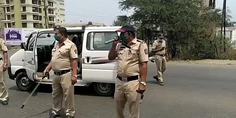 A policeman in Maharashtra raises awarenes of social distancing by a song. (Photo| Twitter)