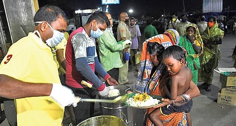 Free cooked meal being distributed among destitute in Bhubaneswar on Friday (Photo | EPS)