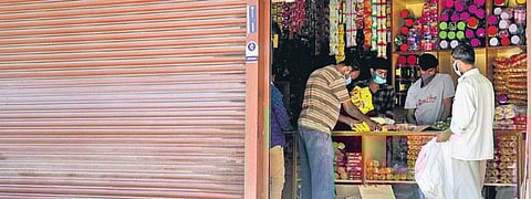 A partially-open general store caters to customer on Saturday | VINOD KUMAR T
