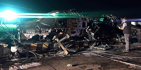 A man shoots video of the wreckage of a Lion Air, West Wind 24 aircraft after it caught fire during take off at Manila's International Airport in Philippines. (Photo | AP)