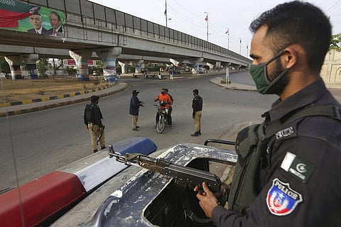 Pakistani police officers stop travelers after a government announced to lockdown the city due to concerns over the spread of the new coronavirus, in Karachi, Pakistan. (Photo | AP)