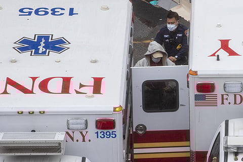 A paramedic transports a patient into the Trauma Center at the Elmhurst Hospital Center, Sunday, March 29, 2020, in the Queens borough of New York.  (Photo | AP)