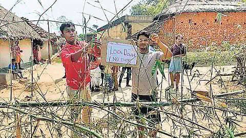 Villagers in West Bengal’s Purulia block roads with makeshift bamboo gates so that migrants returning home can’t enter the village | Express