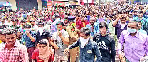 Migrant workers who took to the streets violating lockdown restrictions demanding return to their hometown at Payippad Junction near Changanassery on Sunday. (Photo | EPS/Shaji Vettipuram)