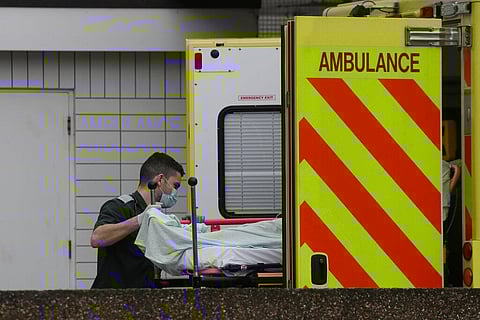 A patients is helped from an ambulance as they arrive at St Thomas' Hospital in London. (Photo | AP)