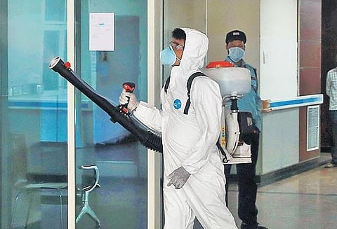A worker sprays disinfectants in Safdarjung Hospital in Delhi on Monday | Shekhar Yadav