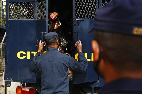 A Nepalese woman requests a policeman to let her go after she was detained for violating curfew rules during lockdown in Kathmandu. (Photo | AP)