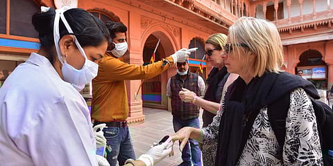 Medics screen tourists in view of the COVID-19 outbreak. (Photo| PTI)