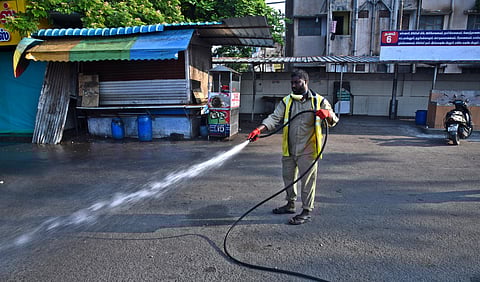 A health worker sanitising a street in Coimbatore on Tuesday. (Photo | A Raja Chidambaram, EPS)