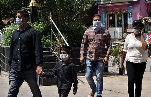 People at Gandhi Hospital wearing handkerchiefs due to lack of masks in Hyderabad (Photo | EPS/S Senbagapandiyan)