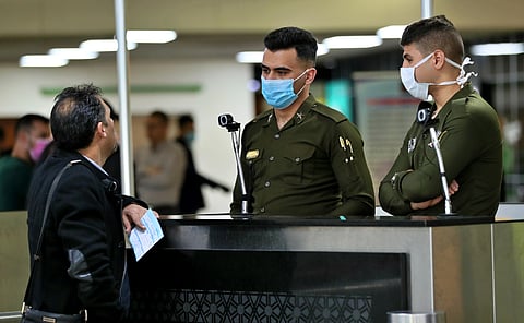 Police officers wear masks at Baghdad Airport, Iraq, Wednesday, March 4, 2020. (Photo | AP)