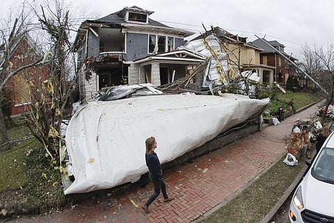 A roof from a nearby business lies in the front yard of a home Wednesday, March 4, 2020, in Nashville, Tenn. Residents and businesses face a huge cleanup effort after tornadoes hit the state Tuesday, killing 24 people and leaving many others missing. (Pho
