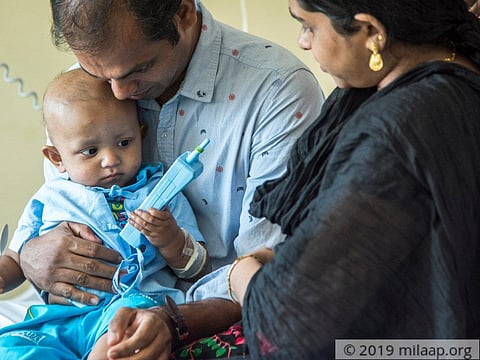 One-year-old Ahan Dev with his parents.