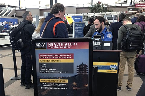 In this Monday, March 2, 2020 file photo, a health alert for people traveling to China is shown at a TSA security checkpoint at the Denver International Airport in Denver. (Photo | AP)