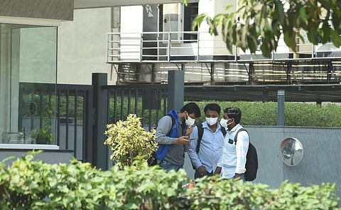 Employees of Hexagon and other offices in Purva summit building coming out as an employee was infected with coronavirus and asked employees to work from home. (Photo | RVK Rao/EPS)