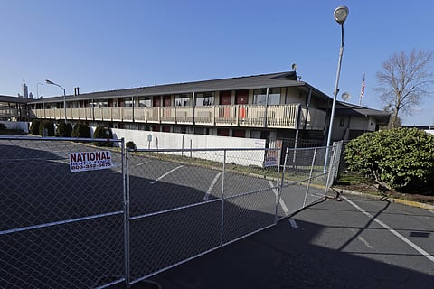 A fence limits access to a back parking area of an Econo Lodge motel in Kent, Wash., Wednesday, March 4, 2020. (Photo | AP)