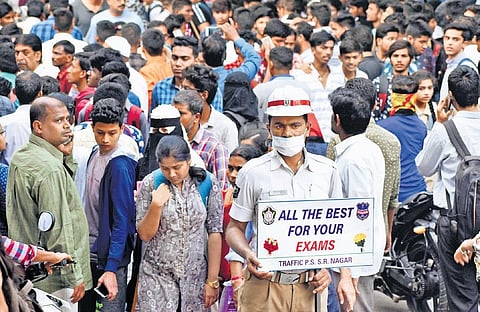 File | A policeman at SR Nagar in Hyderabad wishes students best of luck  on the first day of the Intermediate Public Examinations 