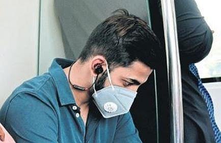 A Metro passenger travels wearing a mask, in Bengaluru on Wednesday  | vinod Kumar T