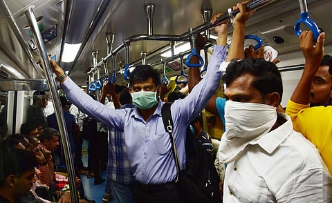 Metro passengers travel wearing a mask, in Bengaluru. (Photo |Vinod Kumar T, EPS)