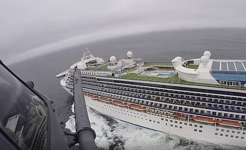 In this image from video, provided by the California National Guard, a helicopter carrying airmen with the 129th Rescue Wing flies over the Grand Princess cruise ship off the coast of California Thursday, March 5, 2020. (Photo | AP)