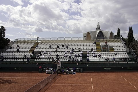 Just a few people sit in the stands as Italy's Fabio Fognini returns a ball to South Korea's Lee Duck-hee during their Davis Cup tennis match in Cagliari, Italy, Friday, March 6, 2020. (Photo | AP)