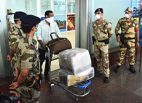 After the outbreak of COVID-19 in neighbouring states, passengers and officials at the Chennai airport are seen using protective masks on Friday (Photo | Ashwin Prasath, EPS)