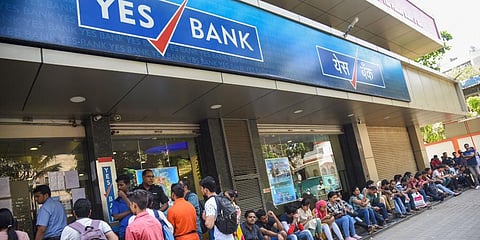 Account holders queue up outside Yes Bank to withdraw money in Mumbai on Saturday. (Photo| PTI)