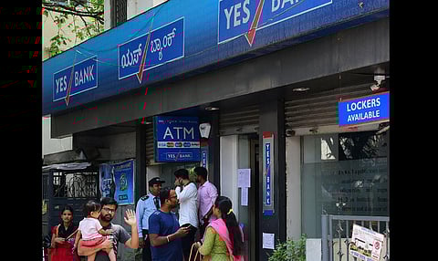 Account holders wait outside Yes Bank to withdraw money at Rajaji nagar Branch in Bengaluru Friday. (Photo | Shriram BN)
