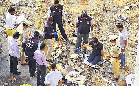 A bomb disposal squad examines the area where an abandoned chemical container caused an explosion in Adugodi, Bengaluru, on Sunday. (Photo | Pandarinath B, EPS)