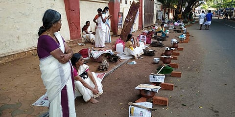 Devotees get ready for offering pongala at the Statue junction in Thiruvananthapuram on Monday as part of the Attukal Pongala festival. (Photo| BP Deepu, EPS)
