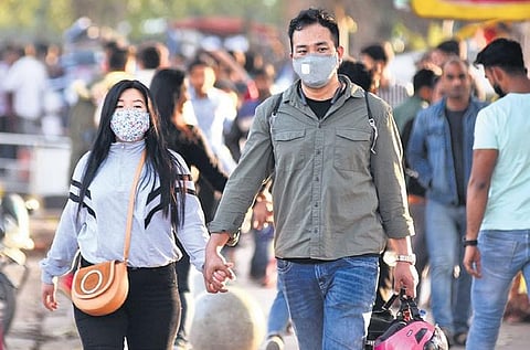 People wear protective masks as a precaution against the coronavirus outbreak in New Delhi on Sunday. (Photo| Parveen Negi, EPS)