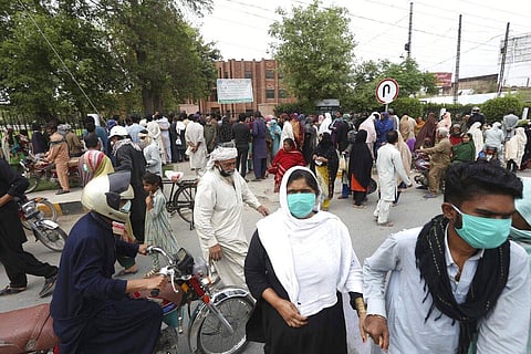 People wait to receive free food supplies provided by the local administration during a lockdown in Multan, Pakistan, Tuesday, March 31, 2020. (Photo | AP)
