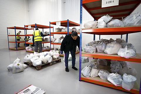 Volunteers help pick items for food packages to help those confined to their homes during the lockdown  in London. (Photo | AP)