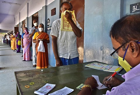 People waiting in queue to collect the token for special relief amount for COVID-19, at Rathinapuri Corporation Higher Secondary School in Coimbatore. (Photo | EPS/ U Rakesh Kumar)