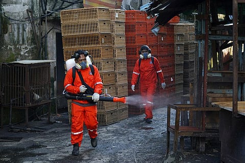 City Hall health officials spray disinfectant at a wet market in Kuala Lumpur, Malaysia, Wednesday, April 1, 2020. (Photo | AP)