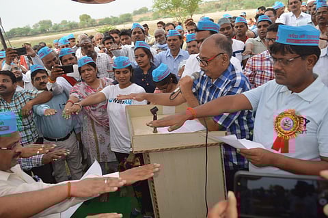 Hira Lal leading the people in taking a pledge for water conservation when he was the District Magistrate of Banda