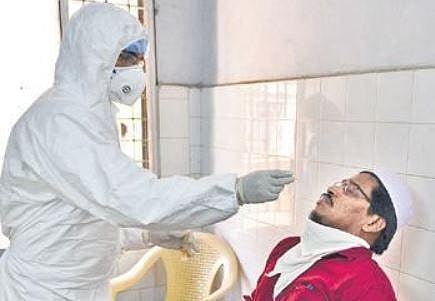 Health workers take nasal samples from a man as part of COVID-19 tests at a healthcare centre in Chennai on Friday | Debadatta Mallick