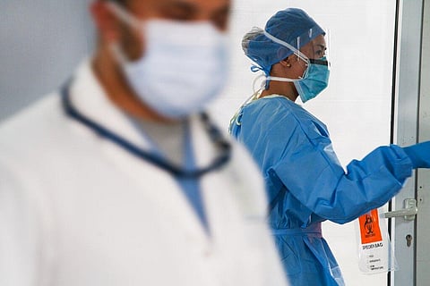 A technician prepares to collect a nasal swab sample from a new coronavirus detection test. (Photo | AP)