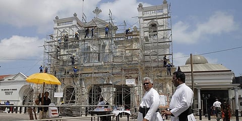 Sri Lankan Catholic priests walk outside the St. Anthony's church after it was partially opened for the first time since Easter Sunday attacks, in Colombo. (Photo | AP)