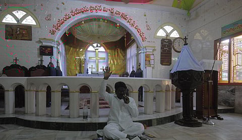 A father prays at an empty church on the occassion of Easter at Tdepalli in Guntur district on Sunday. (Photo | Prasant Madugula, EPS)