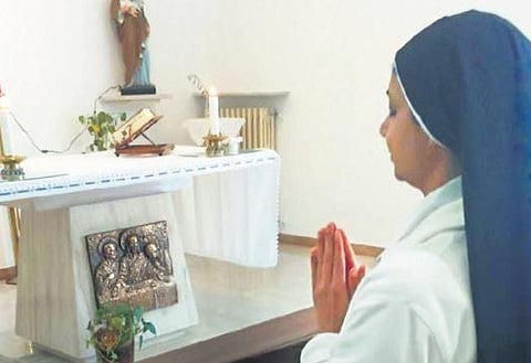 Sr Regina Thuruthiyil prays at a church in Siano, Italy