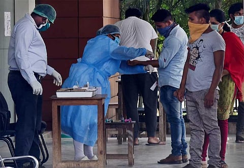 Healthcare workers testing people displaying COVID-19 symptoms, at ESI Hospital in Coimbatore. (Photo | A Raja Chidambaram)