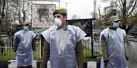 Jammu and Kashmir police personnel wear protective mask during the nationwide lockdown, in wake of COVID-19 in Srinagar. (Photo| ANI)