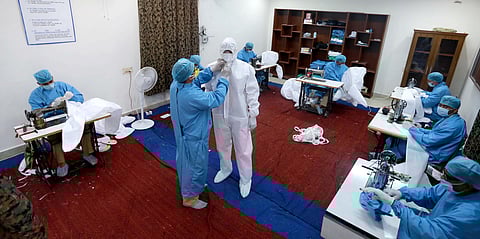 CRPF personnel stitch personal protective equipment (PPE) suits at a camp in RK Puram. The force is now giving kids an opportunity to join the fight (Photo | Shekhar Yadav, EPS)