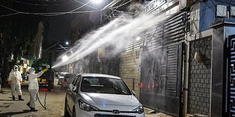 Disaster Response Force team spray disinfectant at Kaladera, Malakpet area to prevent the spread of coronavirus pandemic in Hyderabad. (Photo| PTI)