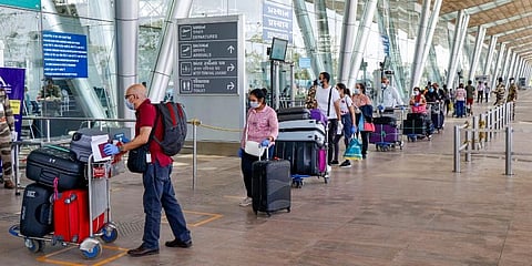 Stranded UK citizens stand at Ahmedabad airport in a queue to catch a flight home during the nationwide lockdown. (Photo | PTI)