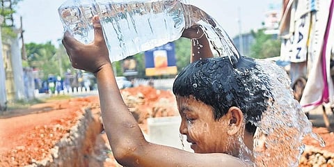 A child enjoys bath as Bhubaneswar temperature soared. (Photo | Biswanath Swain, EPS)