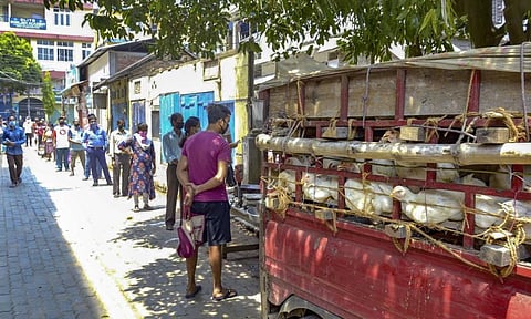 Locals maintain social distance as they stand in a queue to buy chicken during the nationwide lockdown to contain the spread of the coronavirus in Guwahati. (Photo | PTI)