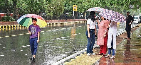 A boy walks during monsoon showers. ( Photo | EPS)