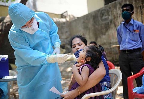 A doctor conducts a swab test in Dharavi slums in Mumbai | PTI